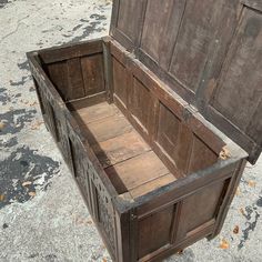 an old wooden box sitting on the ground