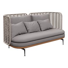 a gray couch with four pillows on it and some black metal poles around the back