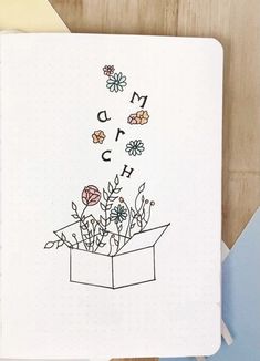 an open notebook with some flowers in it