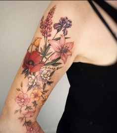 a woman with a flower tattoo on her arm