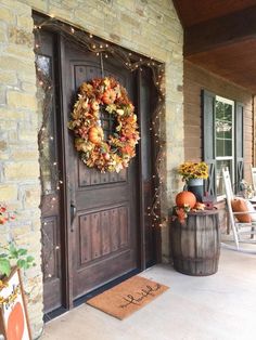 a front door decorated with fall wreaths and pumpkins on the porch for an easy diy project