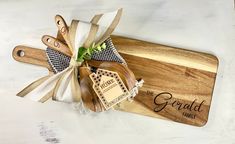 a wooden cutting board and knife set with the words, the grand family on it