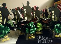 two vases filled with green and red bows on top of a counter next to american flags