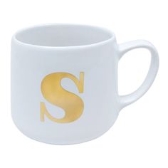 a white coffee cup with gold letters on it