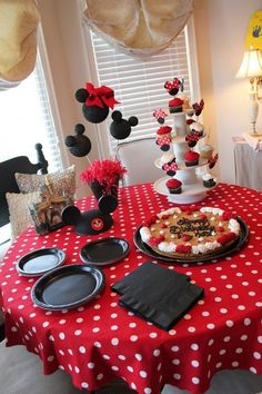 a mickey mouse themed birthday party with food and decorations