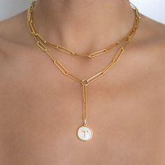 M&M layer sets: We've selected our favorite necklace styles, and put them together in the most perfect way. Wear them with a classic button down, a lace camisole, or a simple graphic tee. Each set is versatile enough to wear with anything. 2 individual necklaces sold together as a SET. Made to Order. Gold filled Pearl Shell Zodiac pendant (16mmx8.5mm) (1) 16" Paperclip chain (2) 20" Paperclip chain lariat Please allow up to 7 business days for processing PRIOR to shipping, which may take an addi Formal Gold-plated Necklace With Paperclip Chain, Elegant Gold-tone Paperclip Chain Charm Necklace, Gold-plated Paperclip Chain Jewelry With Initial Pendant, Luxury Gold-tone Paperclip Chain Necklace, 14k Gold-tone Paperclip Chain Necklace, Lace Camisole, Zodiac Pendant, Simple Graphic, Pearl Shell