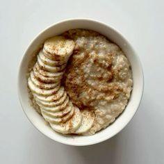 a bowl filled with oatmeal and sliced bananas