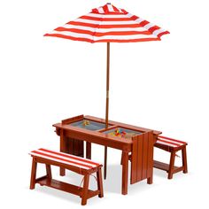 a wooden table with an umbrella over it and two benches under it, both in red and white stripes