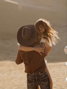 a man and woman hugging in the desert