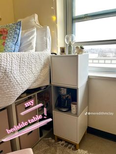 a bed room with a neatly made bed next to a window and a night stand