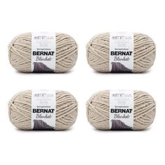 four balls of bernat wool yarn in natural beige, brown and white colors on a white background