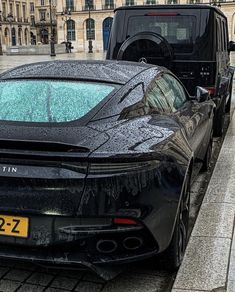 a black sports car is parked on the street