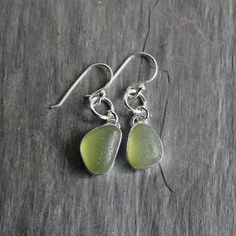 Handmade Sterling Silver Olive Green Bezel Set Sea Glass Dangly Drop EarringsNot only is it a chore to make sea glass earrings, but it is also a bigger challenge to find 2 pieces of sea glass that are similar enough to make a decently matching pair of earrings. Here are the details about these bright green earrings:I used 2 pieces of olive green sea glass from Europe set in sterling and fine silver and attached to handmade sterling silver ear wires. All of my sea glass is found and not altered i Bold Statement Necklaces, Beachglass Jewelry, Sea Glass Earrings, Green Sea, Jewelry Studio, Bubble Mailer, Glass Rings, Dainty Bracelets, Dangly Earrings