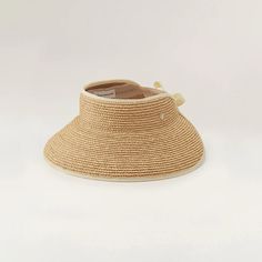 Mita | Natural Sand Wide Raffia Visor Hat | Helen Kaminski Helen Kahminski Hat, Elegant Adjustable Braided Hat, Handwoven Adjustable Straw Hat, Elegant Adjustable Woven Straw Hat, Adjustable Natural Fiber Hats, Packable Natural Straw Hat, Packable Straw Hat In Natural Color, Adjustable Palm Leaf Hat, Packable Natural Color Brimmed Straw Hat