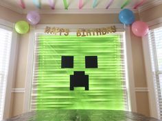 a birthday party with balloons and streamers in the shape of an emo face