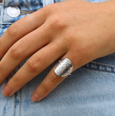 This simple and elegant ring is made by hand using high quality sterling silver materials. It is tarnish resistant and hypoallergenic so you can wear it all day, to the beach, gym etc. without worry of discoloration or irritation to your finger! The large circle center is made from a solid piece of high quality sterling silver sheet metal that has been curved to fit your finger easily and hammered to give it a beautiful shine and texture. The band is thick and strong enough to hold everything in place, but small enough to allow the circle to appear to be floating on your finger. Perfect everyday ring! Also available in 14k gold filled. All jewelry is handmade and I guarantee the workmanship and quality of all my products for one year. I use high quality stones and sterling silver or gold f Minimalist Nickel-free Sterling Silver Engraved Ring, Minimalist Hammered Signet Ring As Gift, Minimalist Sterling Silver Engraved Ring Nickel Free, Minimalist Sterling Silver Engraved Ring, Nickel Free, Handmade Modern Sterling Silver Midi Rings, Modern Handmade Sterling Silver Midi Rings, Classic Sterling Silver Hammered Ring, Adjustable Sterling Silver Stackable Signet Ring, Modern Sterling Silver Hammered Rings