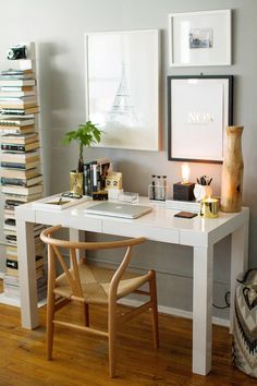 a white desk topped with a laptop computer next to a wooden chair and book shelf