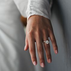 a close up of a person's hand with a wedding ring on their finger