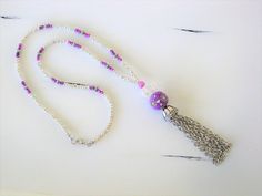 Long Silver and Purple Beaded Necklaces with Tassel handmade by Ralston Originals. These beaded necklaces come in your choice of Styles. I made the first purple tassel necklace (pictures 1 - 4) with a large purple crackle glass bead, a large antique silver metal bead on top of it, followed by a blue ceramic bead with antique silver metal bead caps surrounding it. The beaded chain is made with silver seed beads, purple seed beads, and a purple and blue bead. I made the tassel with silver metal ch Adjustable Beaded Chain Tassel Necklace As Gift, Beaded Tassel Dangle Necklace For Gifts, Beaded Dangle Tassel Necklace For Gift, Gift Beaded Dangle Tassel Necklace, Handmade Dangle Tassel Necklace For Gift, Silver Beaded Necklace, Assemblage Necklace, Beaded Tassel Necklace, Blue Beaded Necklace