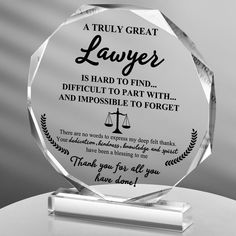 a clear glass award with an image of a lady justice quote on the front and back