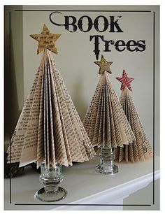 three paper christmas trees on a shelf with the words book trees written in black and white