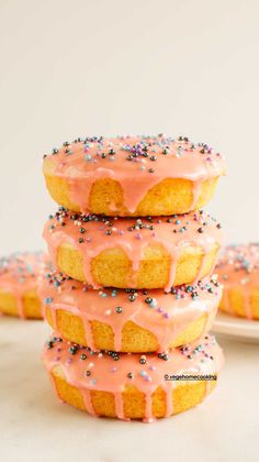 eggless and baked vanilla donuts with sprinkles stacked on each other