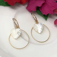 The breezy, beachy ears are so gorgeous and light! They feature carved mother of pearl palm leaves that are gracefully suspended from hand-twisted hoops and French ear wires. Designed in your choice of 14kt yellow gold filled, 14kt rose gold filled or sterling silver. Very comfortable on the lobes, they simply dance in the light! Elegant Hypoallergenic Earrings For Beach, Delicate White Jewelry For The Beach, Hypoallergenic White Jewelry For Vacation, Elegant Round Hoop Earrings For The Beach, Elegant Earrings With Ear Wire For Vacation, White Round Earrings For Beach, Elegant White Hoop Earrings For Beach, Beach Earrings Made Of Mother Of Pearl, White Hoop Earrings For Vacation