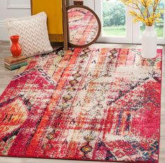 a colorful area rug in front of a window