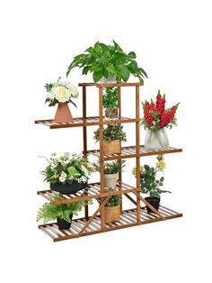 a wooden shelf filled with potted plants on top of each other next to flowers