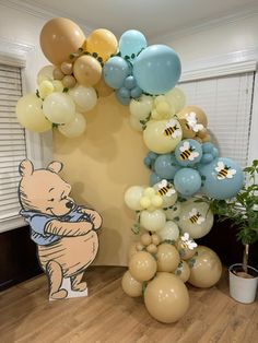 winnie the pooh balloon arch with honeybee balloons