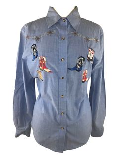 Roughrider by Circle T Women's Vintage Western Cowboy Boot Button Up Shirt L. Condition is "Pre-owned". Shipped with USPS First Class. Great condition vintage roughrider western shirt! Embroidered with cowboy boots! Denim blue fabric style, there is a slight imperfection on the bottom of the shirt ( see pictures) All measurements taken laid flat Length: 27” Chest: 22.5” Spring Rodeo Button-up Shirt, Cotton Tops With Buttons For Rodeo, Western Collared Top With Buttons, Western Blue Button-up Top, Spring Western Shirt With Button Closure, Western Style Blue Tops With Buttons, Blue Rodeo Top With Snap Buttons, Blue Snap Button Tops For Rodeo, Blue Snap Button Top For Rodeo