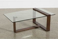 a glass and wood coffee table on concrete floor