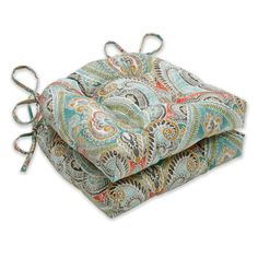 two cushions with ties tied together on top of each other, both patterned in paisley patterns