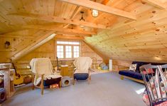 an attic with wood paneling and lots of furniture