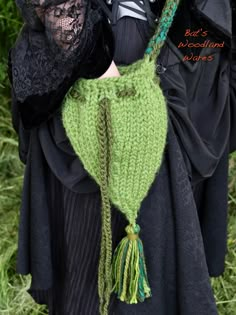 a close up of a person wearing a costume and holding a green item in their hands