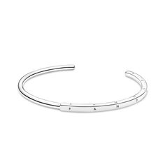 Streamline your look with the Pandora Signature ID Bangle. With a half-squared, half-rounded profile, this bangle is hand-finished in sterling silver. The round polished profile transitions to a larger squared profile in the middle, which features the Pandora logo on its three outer sides. Each end of the bangle includes the Pandora Crown O monogram. The bangle is precisely sized for optimal performance and fit and is not designed to be flexed and twisted when put on and removed. Luxury Round Sterling Silver Bangle, Luxury Classic Sterling Silver Bangle, Pandora Bangle Waves Retired, O Monogram, Adjustable Nickel-free Sterling Silver Bangle, Adjustable Sterling Silver Nickel-free Bangle, Pandora Logo, Silver Bangle Bracelet, Sterling Silver Bangle