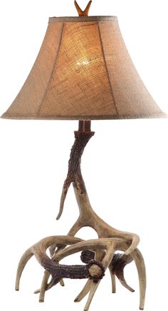 an antler lamp with a brown shade on it's base and a white background