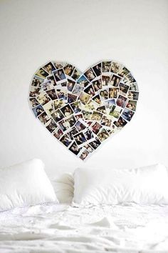 a heart shaped photo hanging on the wall above a bed