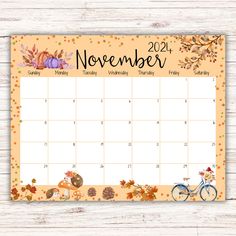 a printable november calendar with autumn leaves, pumpkins and a bike on it