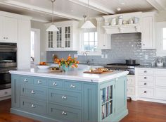 a kitchen with white cabinets and an island in the middle is featured on this page