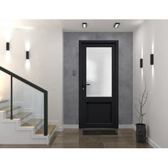 a black door is in the middle of a white room with stairs leading up to it