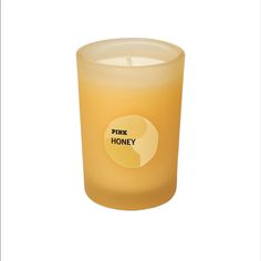 a yellow candle with the words pure honey on it