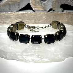 Dare to get noticed in our bold crystal line bracelet. Featuring a sultry row of onyx black 12x10mm luxury European crystals, this piece sparkles with an understated elegance. While it's certainly able to stand on it's own, you'll find it effortlessly layers with whatever you may choose to pair it with.  Our bracelets are adjustable from 7.25 to 8.25 inches so that you get a truly custom fit. This listing is for one single strand bracelet.  Rew Elliott...Timeless, Tasteful, Treasured.  See more gorgeous treasures from Rew Elliott here: http://www.etsy.com/shop/rewelliott All Rew Elliott pieces are handmade in the U.S.A. and are nickel free. Every brilliant stone is hand set with care and precision. Jewelry Care  As a general rule, your jewelry should be the last thing you put on in the mor Vintage Black Jubilee Bracelet, Elegant Black Multi-stone Jewelry, Black Multi-stone Fine Jewelry, Luxury Black Jewelry With Gold-tone Hardware, High-end Black Luxury Bracelets, Pearl Bar Necklace, Crystal Ball Necklace, Bracelet Tennis, Ball Necklace