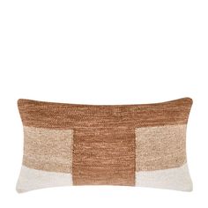 a brown and white pillow on a white background