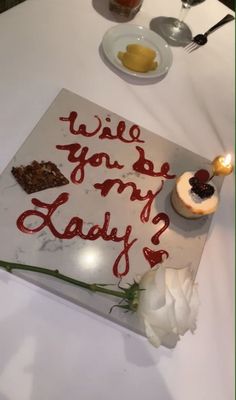 a birthday cake with candles on it that says, will you be my lady?