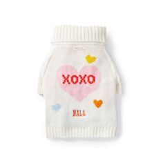 a white dog sweater with the word xoxo on it and hearts in red