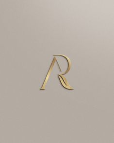 the letter r is made up of gold foil and has a curved design on it