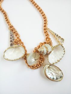 "Unused vintage statement seashell chain necklace with 24K edged seashell charms. The chain is made of aluminum with a gold tone plate of excellent quality and lightweight. This bold necklace is a great an original and daring piece, which will look great as part of a dress up occasion any time of the year, and also a lovely complement for a beach wedding. Please note that the shells may show small irregularities, as occurs in nature. MEASUREMENTS: Length not including clasp: 17.6\" = 44.5 cm. Ch Unique Gold Shell Necklaces, Gold Shell Necklace With Ocean-inspired Style, Gold Shell Necklace Ocean-inspired, Gold Shell Ocean-inspired Necklace, Vintage Gold Beach Jewelry, Vintage Gold Jewelry For Beach, Gold Ocean-inspired Shell Necklace, Vintage Gold Jewelry For The Beach, Handmade Vintage Gold Shell Necklace