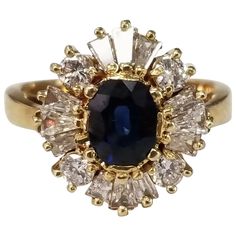 14l yellow gold sapphire and diamond ring, containing 1 oval sapphire of gem quality weighing 1.00cts. and 4 round diamonds weighing .30pts. and 12 baguette cut diamonds weighing .56pts. This ring is a size 5.5 but we will size to fit for free. Diamond Ballerina Ring, Vintage Cluster Ring, Ballerina Ring, Baguette Diamond Rings, White Gold Sapphire, Sapphire And Diamond Ring, Cluster Rings, Blue Sapphire Diamond, Diamond Cocktail Rings