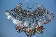 "UNIQUE rare large ETNIC BOHO vintage 1960s Ottoman-style handmade ornamented silvercolor metal pendants necklace collar choker with 25 hanging pendants/ charms, 3 of them with red/ white cabochons. Round pendants coins has picture of Queen Elisabeth and text Queen Elisabeth the 2nd. Chains are connected with spring ring clasp. Size:   17.75 \"/ inch or 45 cm long with chain and collar.  Exellent condition." Vintage Metal Coin Pendant Necklace, Ornate Metal Choker Necklace, Festival Silver Metal Choker, Vintage Silver Choker Necklace, Festival Decorative Silver Jewelry, Silver Bohemian Choker For Party, Silver Decorative Jewelry For Festivals, Silver Metal Choker For Costume Jewelry, Silver Metal Costume Jewelry Choker